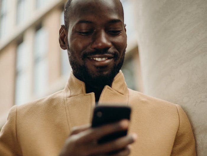 man smiling at phone