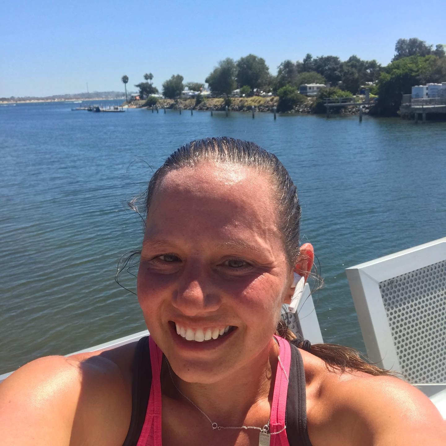 runner Justine Galloway takes a selfie with water in the background.
