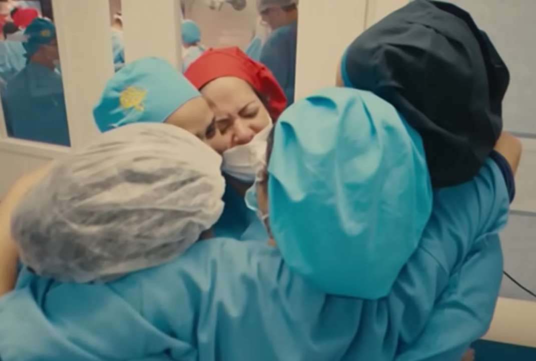 nurses hug and cry after performing 33 hour surgery to separate cojoined twins.