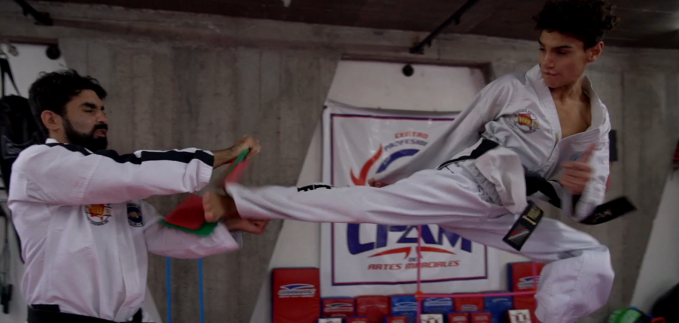 Nazareno doing taekwondo with instructor