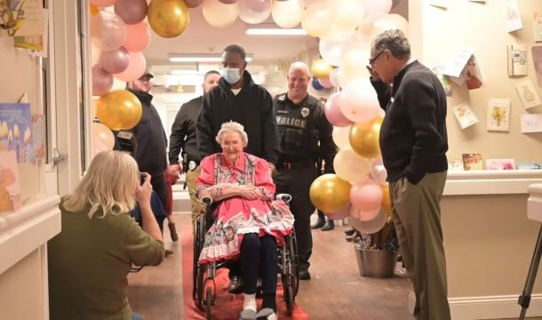A woman named Lorene Summey is being escorted into her birthday party.