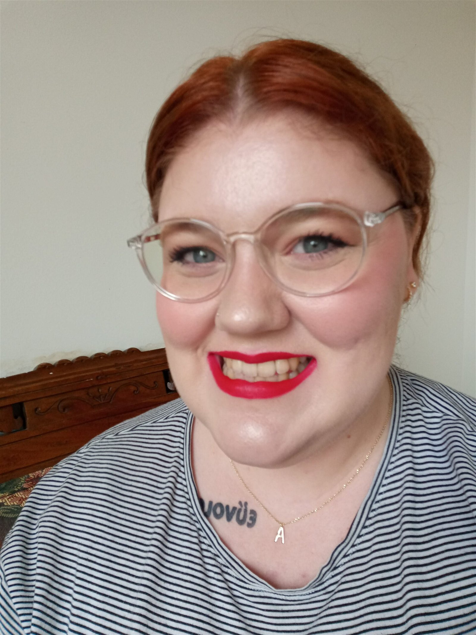 a woman wearing red lipstick with fairly yellow teeth